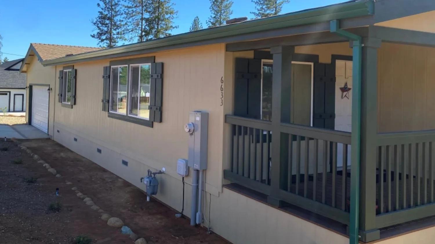 Color-matched gutters on a single-story home with a covered porch